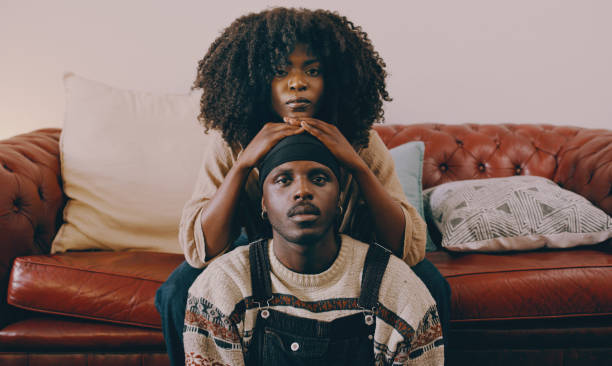 Shot of a young couple relaxing on the sofa at home